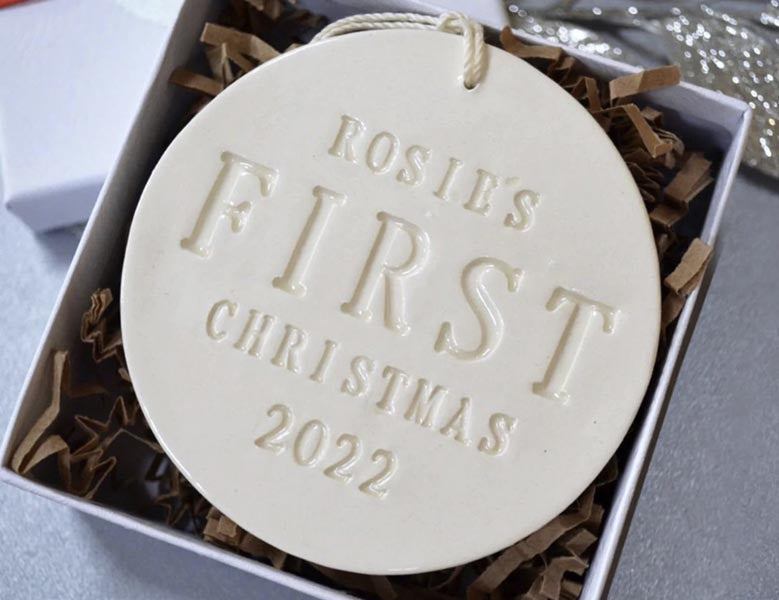 handmade ceramic holiday ornament personalized with baby's first Christmas name and year