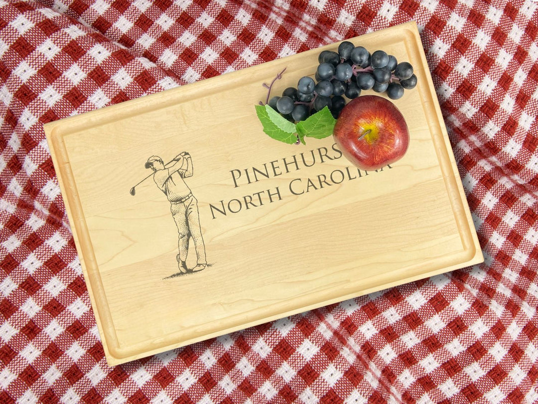 Personalized maple hardwood cutting board with an engraved design of a golfer