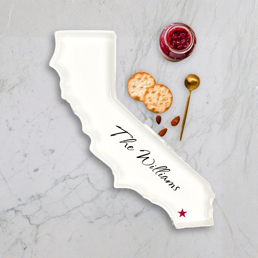 State-shaped serving dish with 'The Williams' engraving on a marble surface.