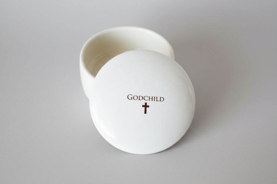 White container with 'GODCHILD' and a cross on the lid
