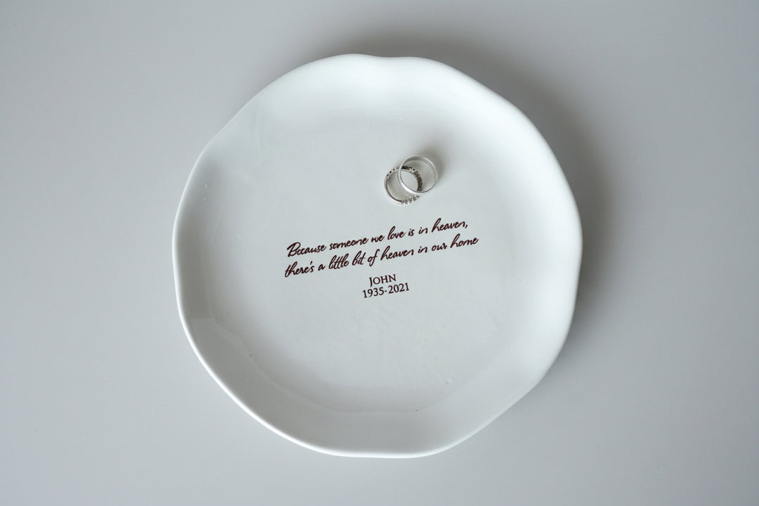 White dish with engraved text on a smooth surface