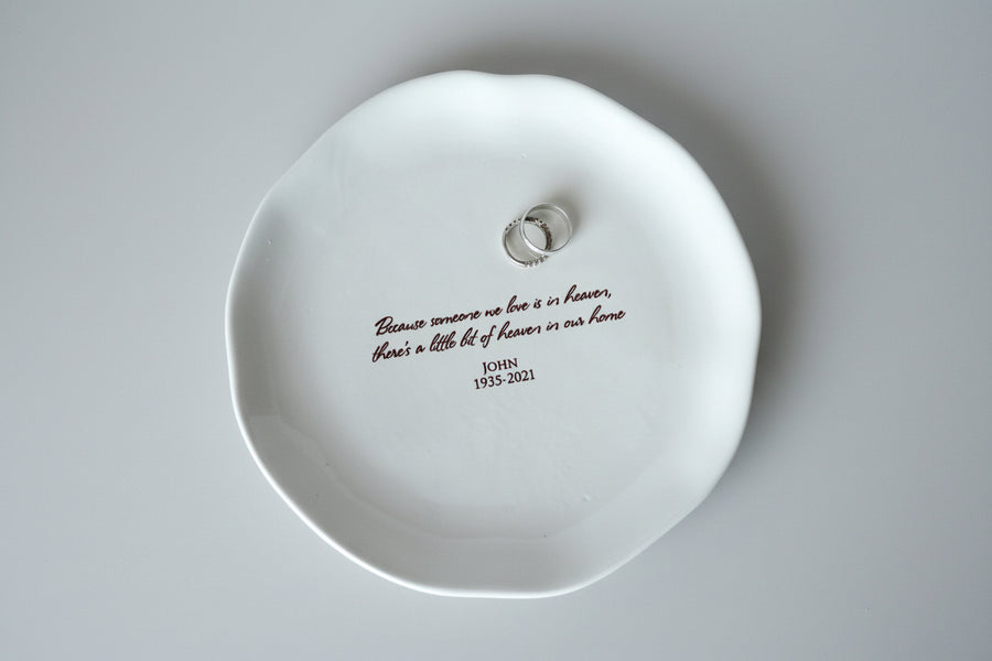 White dish with engraved text on a smooth surface