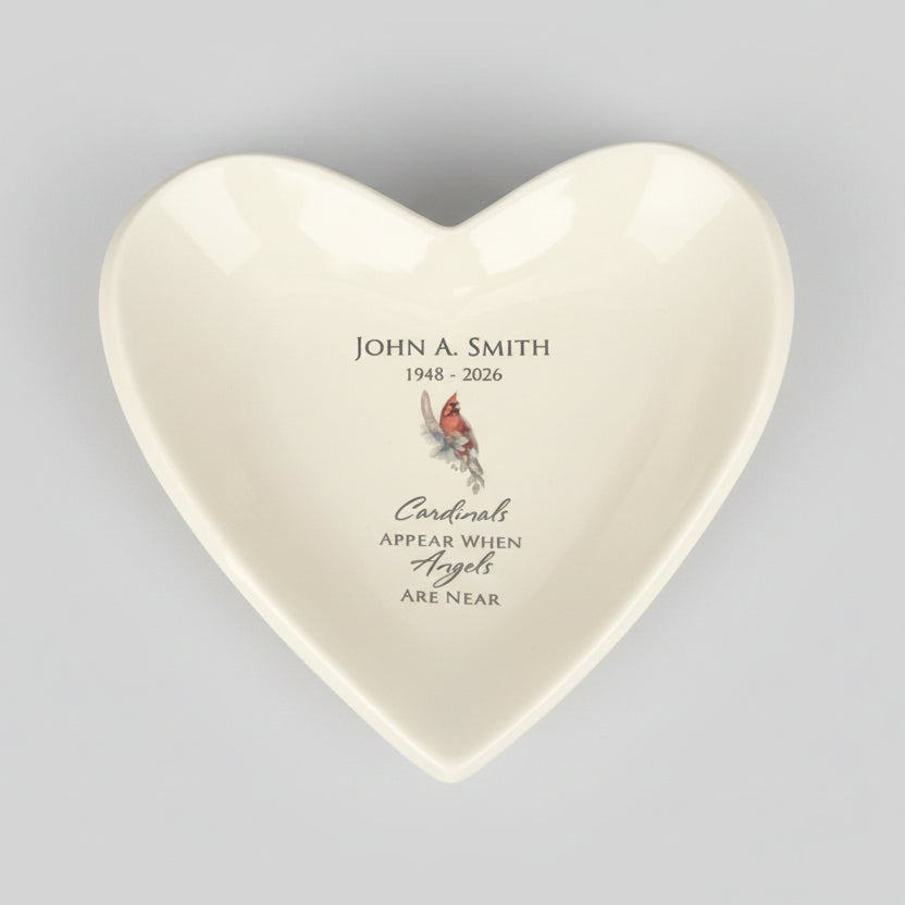 Heart-shaped ceramic plate with imprinted text and a colorful cardinal illustration