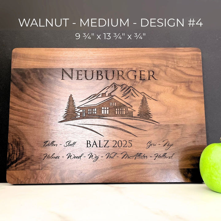 Wooden cutting board with engraved design and text, featuring a house illustration and family branding.