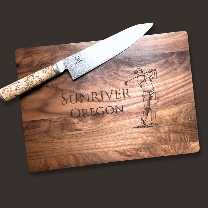 Wooden cutting board with engraved 'Sunriver Oregon' and a golf swing illustration.