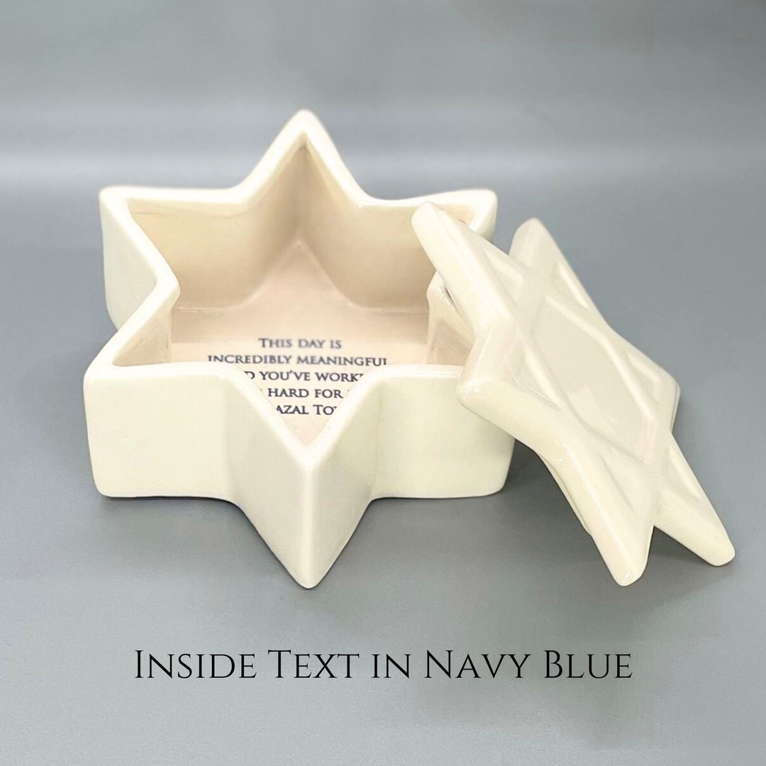Star-shaped ceramic box with blue text on a gray background