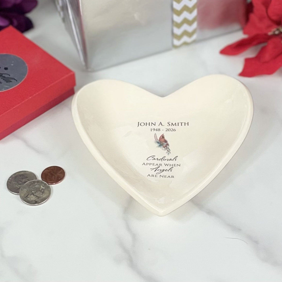 Heart-shaped decorative bowl with custom text on a white surface