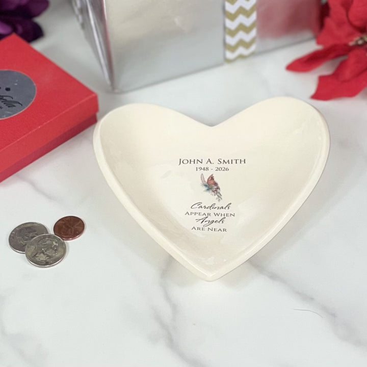 Heart-shaped decorative bowl with custom text on a white surface