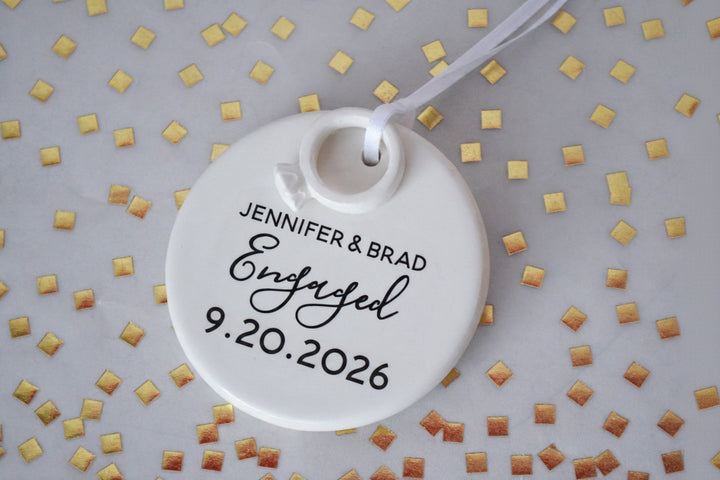 Round white ceramic tag with engraved text on a patterned background