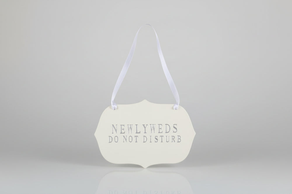 Decorative handmade ceramic sign  'NEWLYWEDS DO NOT DISTURB' text.