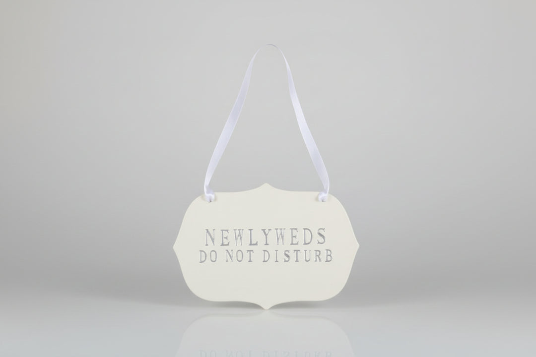 Decorative handmade ceramic sign  'NEWLYWEDS DO NOT DISTURB' text.
