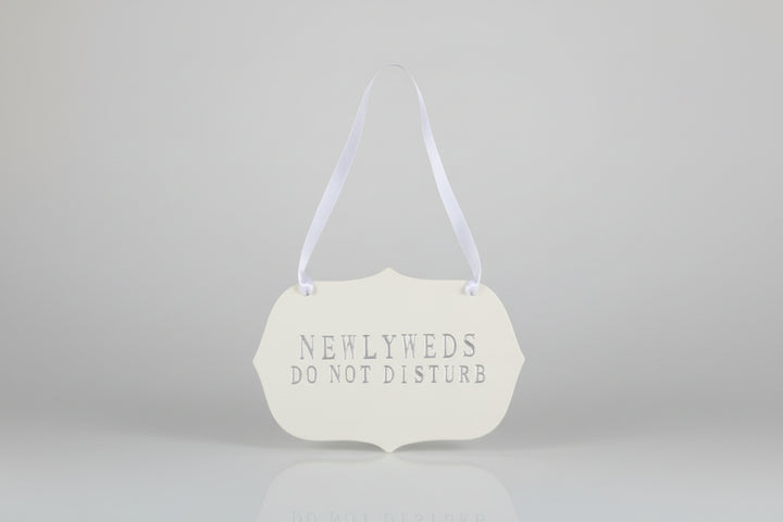 Decorative handmade ceramic sign  'NEWLYWEDS DO NOT DISTURB' text.
