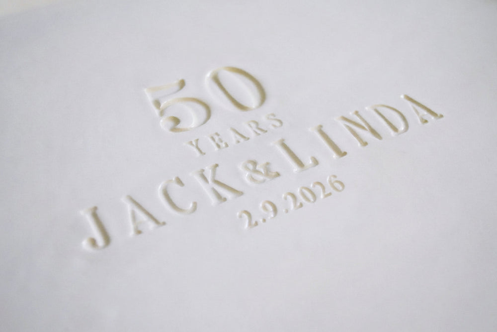 Embossed text on a white surface reading '50 years Jack & Linda 2.9.2026'.