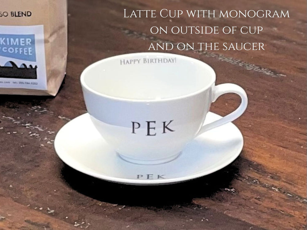 coffee cup with monogram on outside and saucer