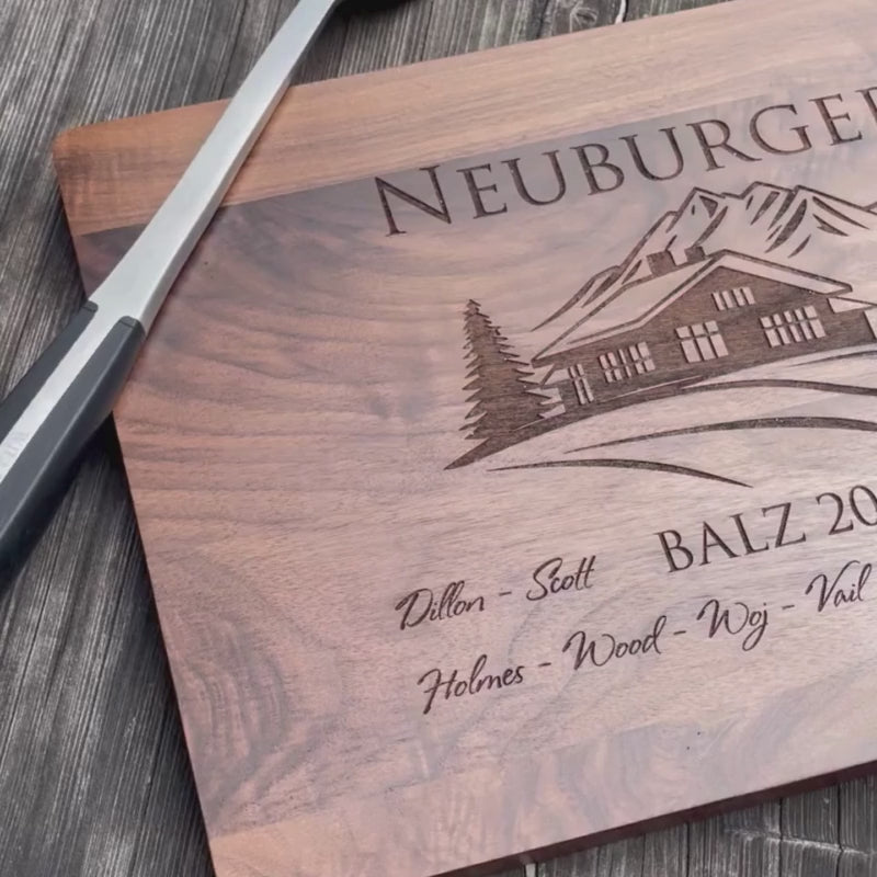 video of family name and vacation home image on a walnut cutting board