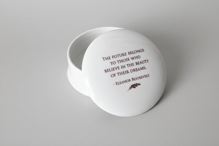 White decorative box with a quote by Eleanor Roosevelt on a marble surface.