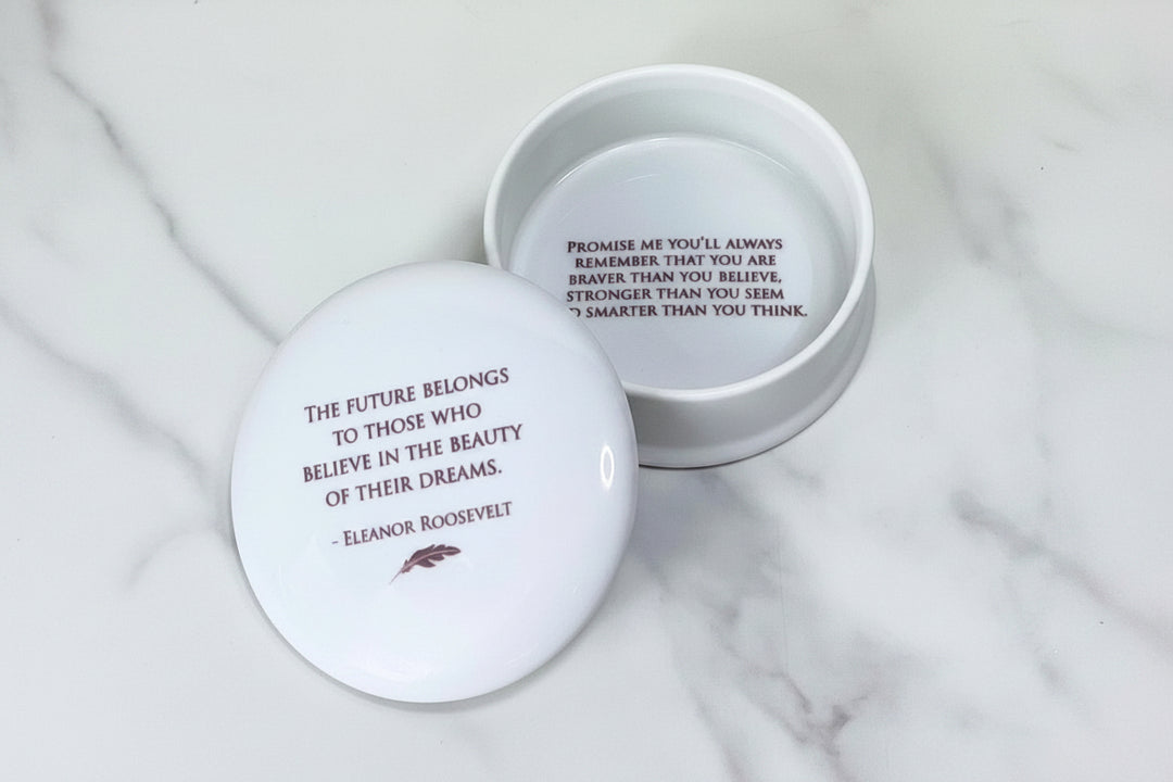 white containers with inspirational quotes on a marble surface.