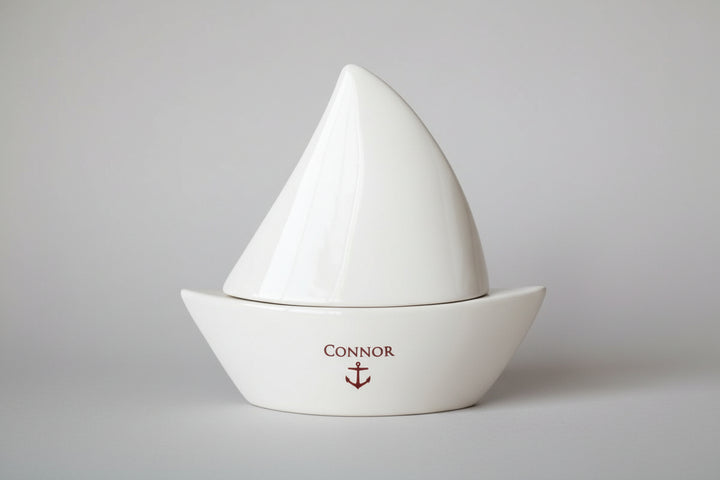 White sailboat-shaped object with 'Connor' and an anchor 