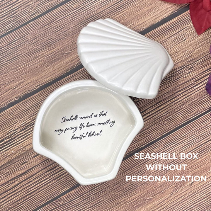 Seashell-shaped box on a wooden surface with text inside, labeled 'Seashell Box Without Personalization'.