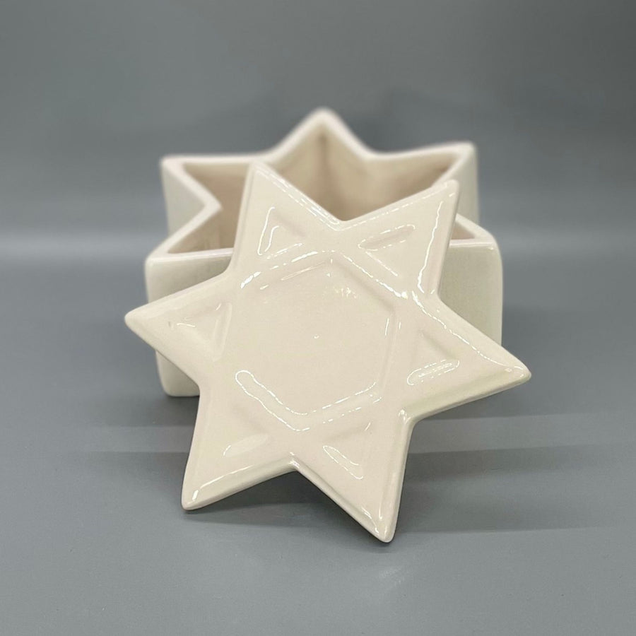 Star-shaped ceramic keepsake on a gray background