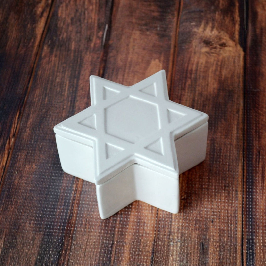 White star-shaped object on a wooden surface