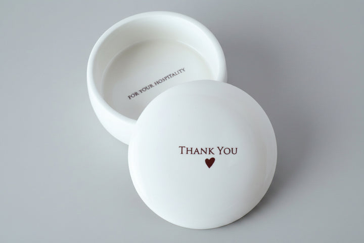 White ceramic bowl with 'Thank You' and heart design on a gray background