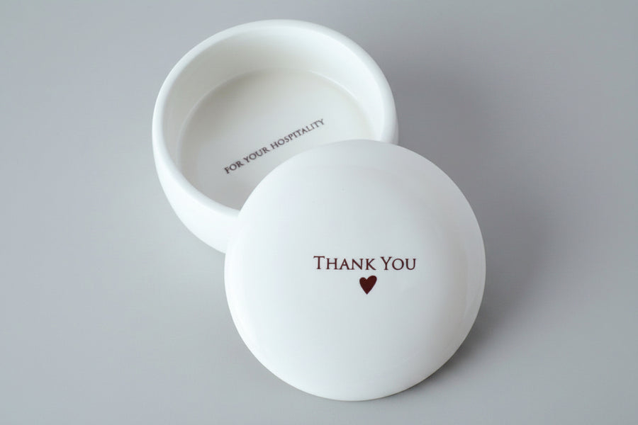 White ceramic bowl with 'Thank You' and heart design on a gray background